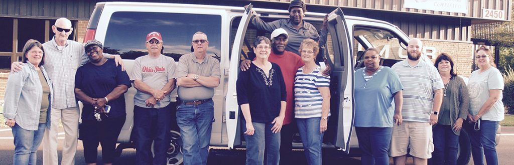 Large group of individuals standing out side a Marimor Industries van